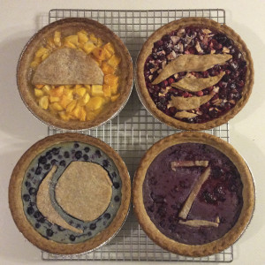 A photo of four shfit-themed pies.