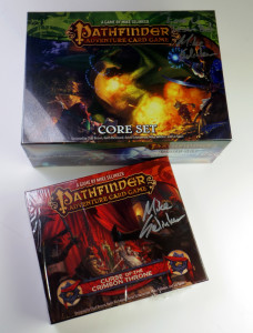 A photo of the prize lot, featuring the Pathfinder Adventure card game, signed.