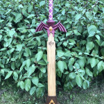 A wooden master sword set in a wooden base.