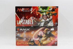 Two boxes of Magic: the Gathering cards stacked on top of each other. The top box, Unstable, features a person dressed as a very strange scientist with a broad grin. The second box, Battlebond, shows a large ogre surrounded by cards.
