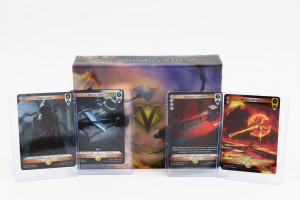 Four Magic: the Gathering cards stand up right, facing the camera, in front of a box with a giant gold V on it. The words" Varia Starter Set are visible at the top of the box.