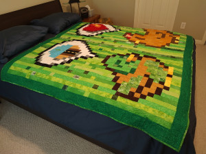A queen-sized bed displayed a large quilt with a pixelized duck and chicken from Stardew Valley. A speech bubble above the duck displayed the Desert Bus logo, and the chicken has an answering speech bubble with a heart.