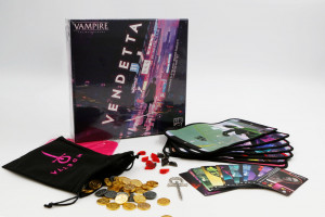 A box of "Vampire: The Masquerade Vendetta" stands on its side next to a felt black bag with gold tokens spilling out of it. Arrayed to the right-hand side there's a collection of play-mats and cards.