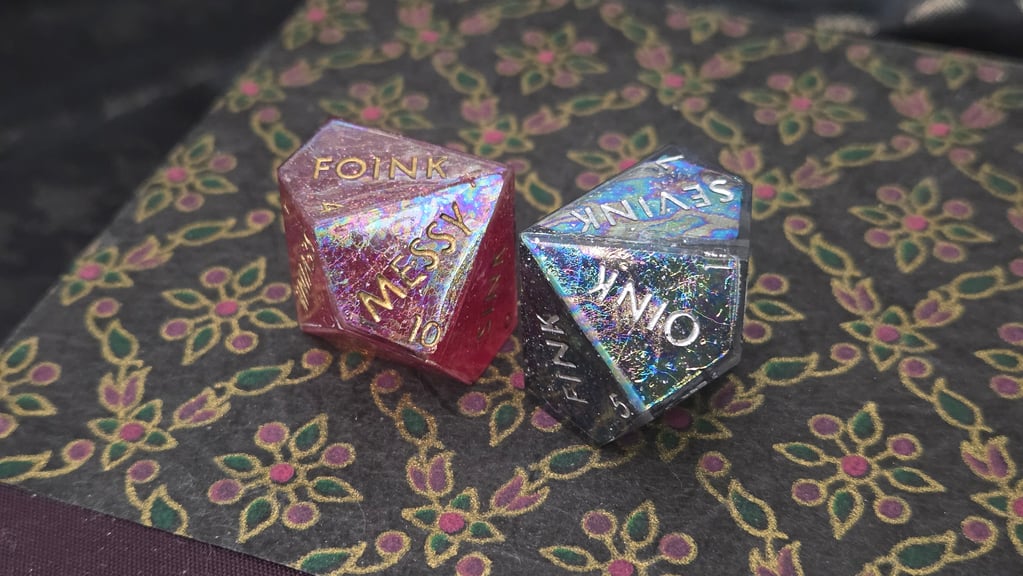 Two d10 dice with an experimental holographic foil treatment near the surface that creates a fine swirled effect.