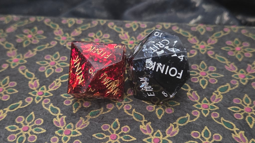 Two d10 Dice with gold and sillver foil inclusions.