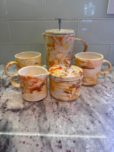 Full set featuring a French press, two mugs, a creamer, and a sugar bowl.