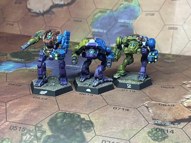 A Grendel, Adder, and a Nova Omnimech painted in Unbound yellow, red, blue, and purple on a desert map