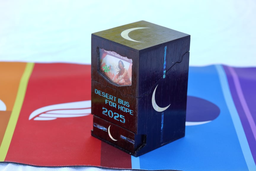 The Night Watch box standing alone. There are blue stripes highlighting the moon logo on the side and drawer.