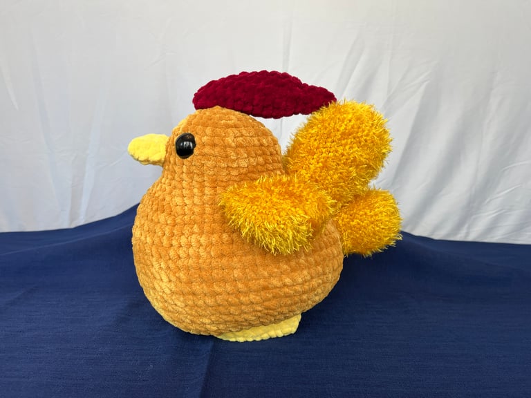 A side profile view of the golden chicken. Highlights the tail shape and the larger comb.