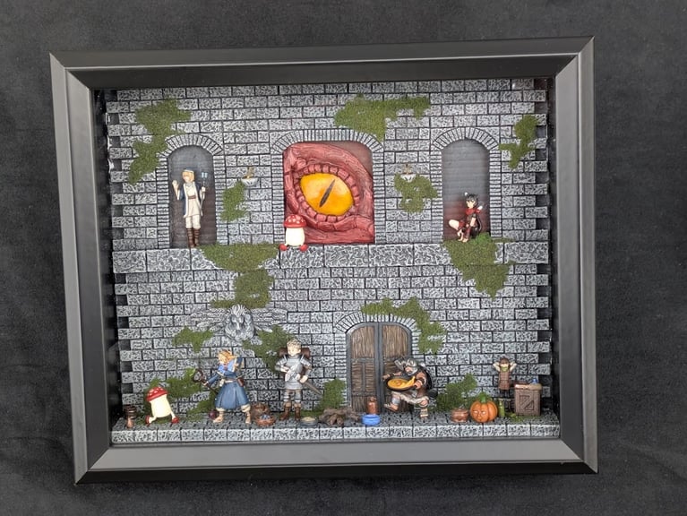 A framed 9"x11" (23 x 28cm) diorama of 6 main characters from the Delicious in Dungeon series. Laios, Chilchuck, Marcille, and Senshi prepare a meal, while several walking mushrooms and a dryad pumpkin keep watch. Falin, Izutsumi, and a giant red dragon eye peer down from arches on the stone wall above.