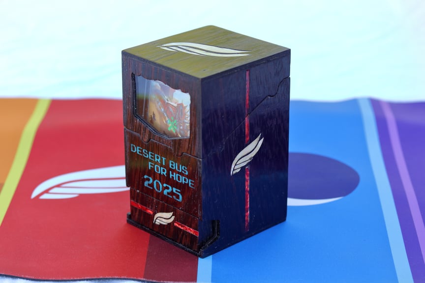 The Alpha Flight box standing alone. There are red stripes highlighting the wing logo on the side and drawer, and the card visible within is Untethered Express.