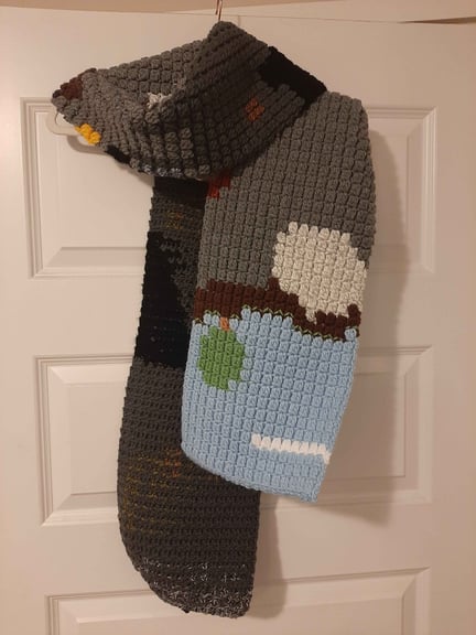 Scarf draped over a hanger in a way it might be worn