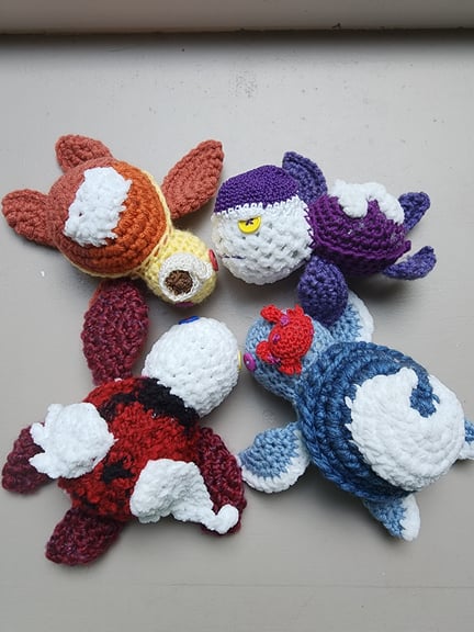 The 4 main turtles from above, showing their shells off, each that has appliqué details to represent each shift