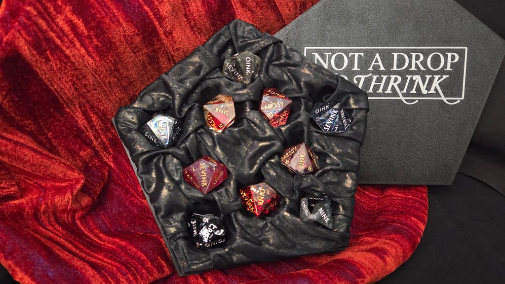 The full set of five black normal dice and five red hunger dice in their box.  Instead of numbers, these dice show the word for each number with the letters INK at the end.  OINK, TWINK, THRINK, etc.
