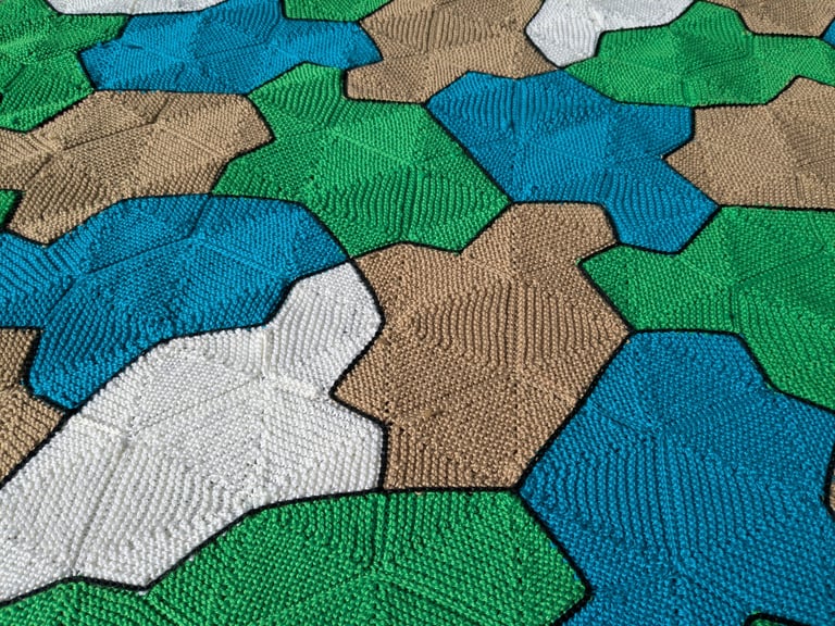 A close-up of the blanket. At this distance, a triangular/hexagonal grid is visible. Each turtle is made from segments of this grid.