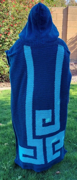 5'5" (165 cm) tall person from the back wearing a dark blue cape with light blue geometric pattern and hood.  The cape is inspired from Legend of Zelda: Echoes of Wisdom.
