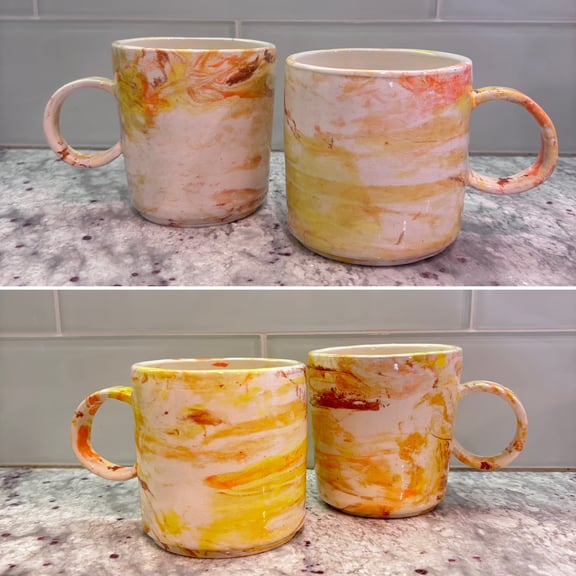Two views of the mugs as a pair, highlighting the color marbling.