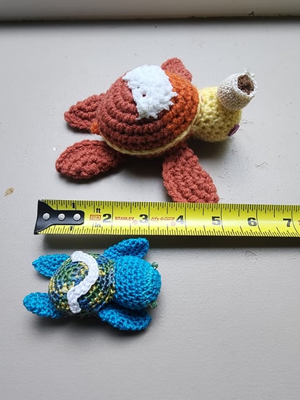 Dawnguard and omega, with a measuring tape, to show their relative sizes