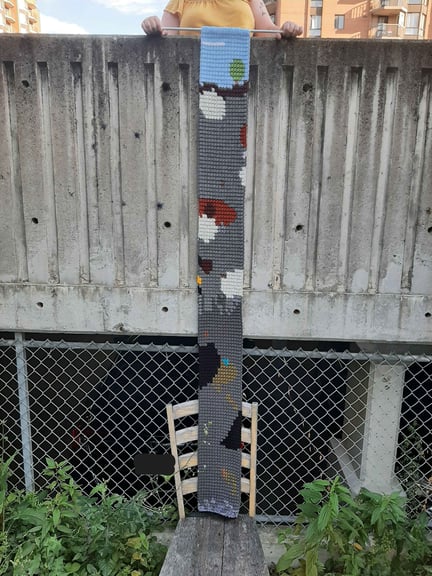 A wide view showing the entire length of the scarf, from the flat Minecraft cloud all the way down to bedrock and the void beneath