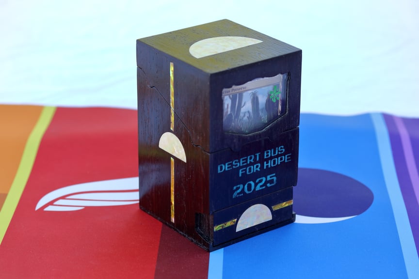 The Dawn Guard box standing alone. There are yellow stripes highlighting the rising-sun logo on the side and drawer, and the card visible inside is Cactus Preserve.
