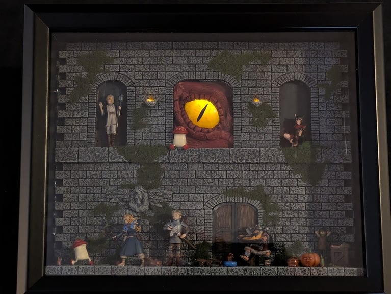The entire diorama, this time shown in a dark room. The glowing eye and torches are clearly visible and striking.
