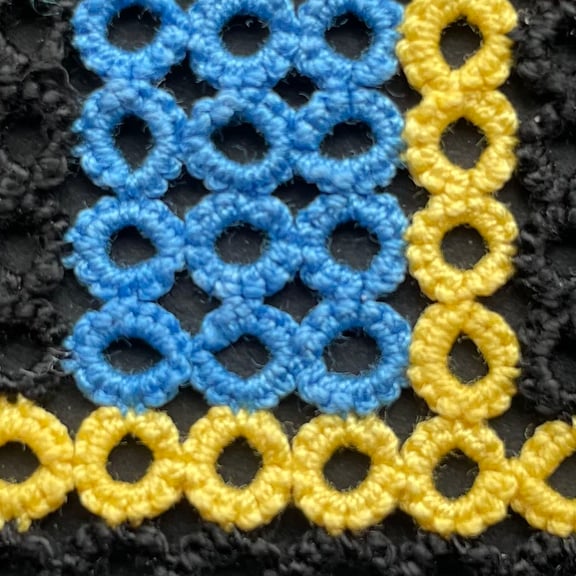 Extreme close up of the lace. You can see all the individual knots that make up each ring.