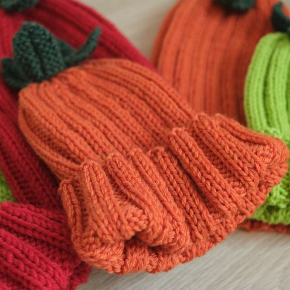 A close up of the ribbing texture on an orange knit hat.